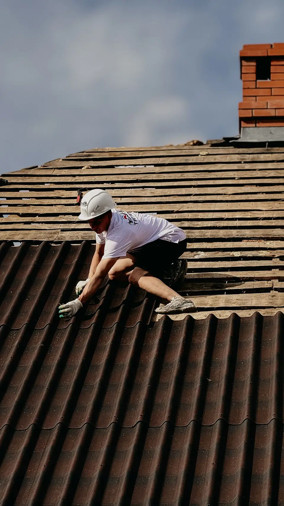 Roofer working across a tile roof
