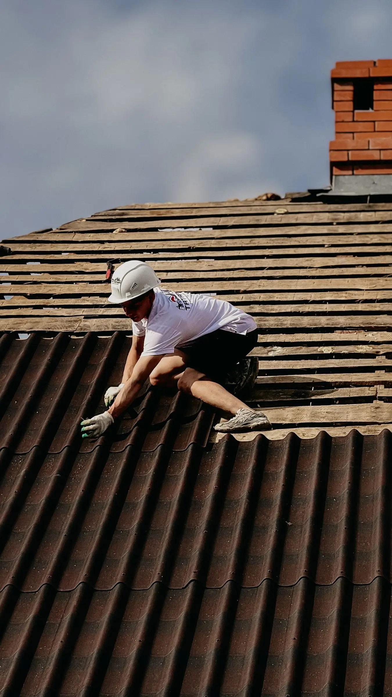 Roofer working across a tile roof