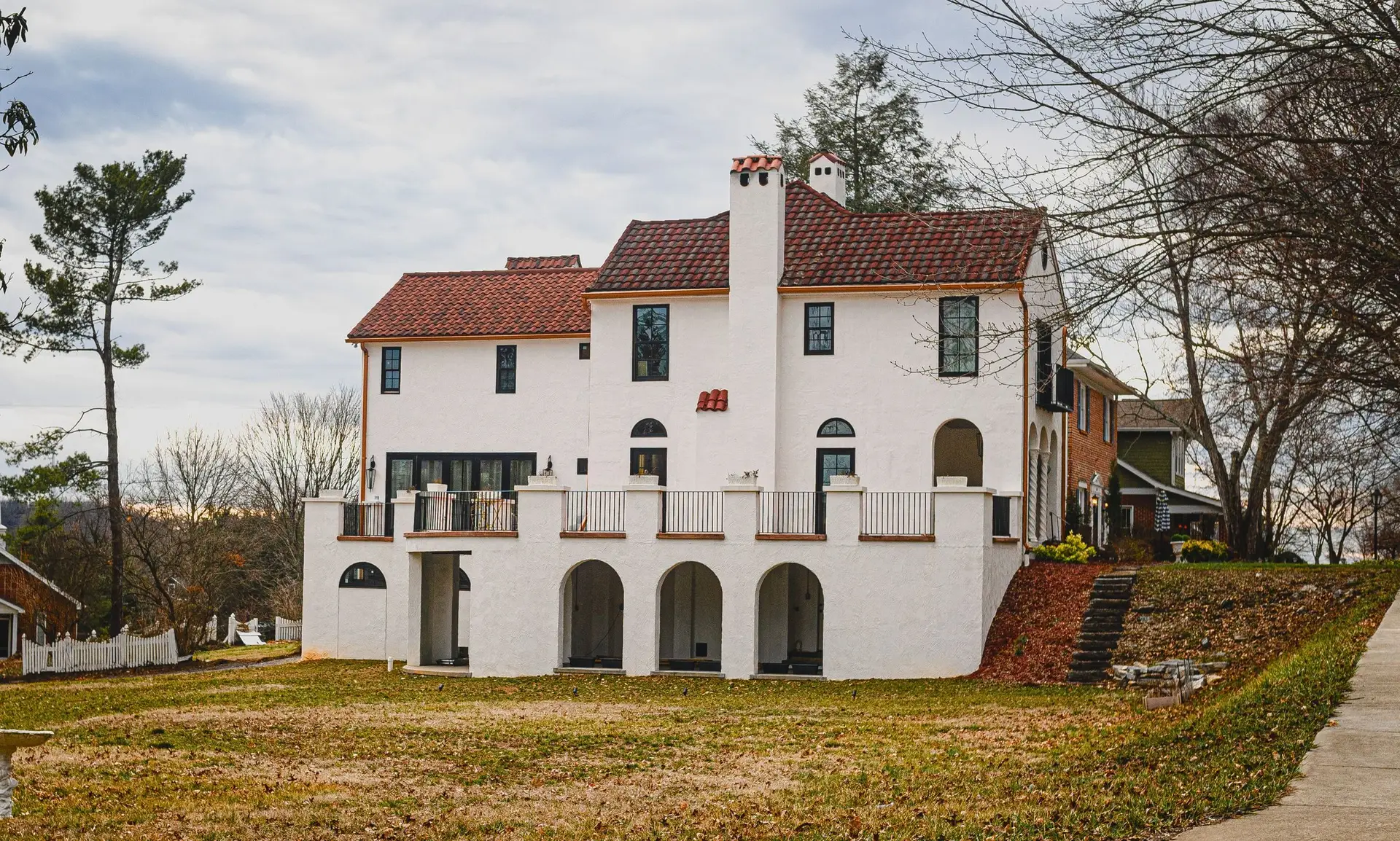 White Spanish-style home with arches and a tile roof