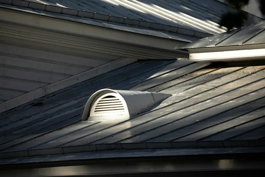 Metal roof with a roof vent up close