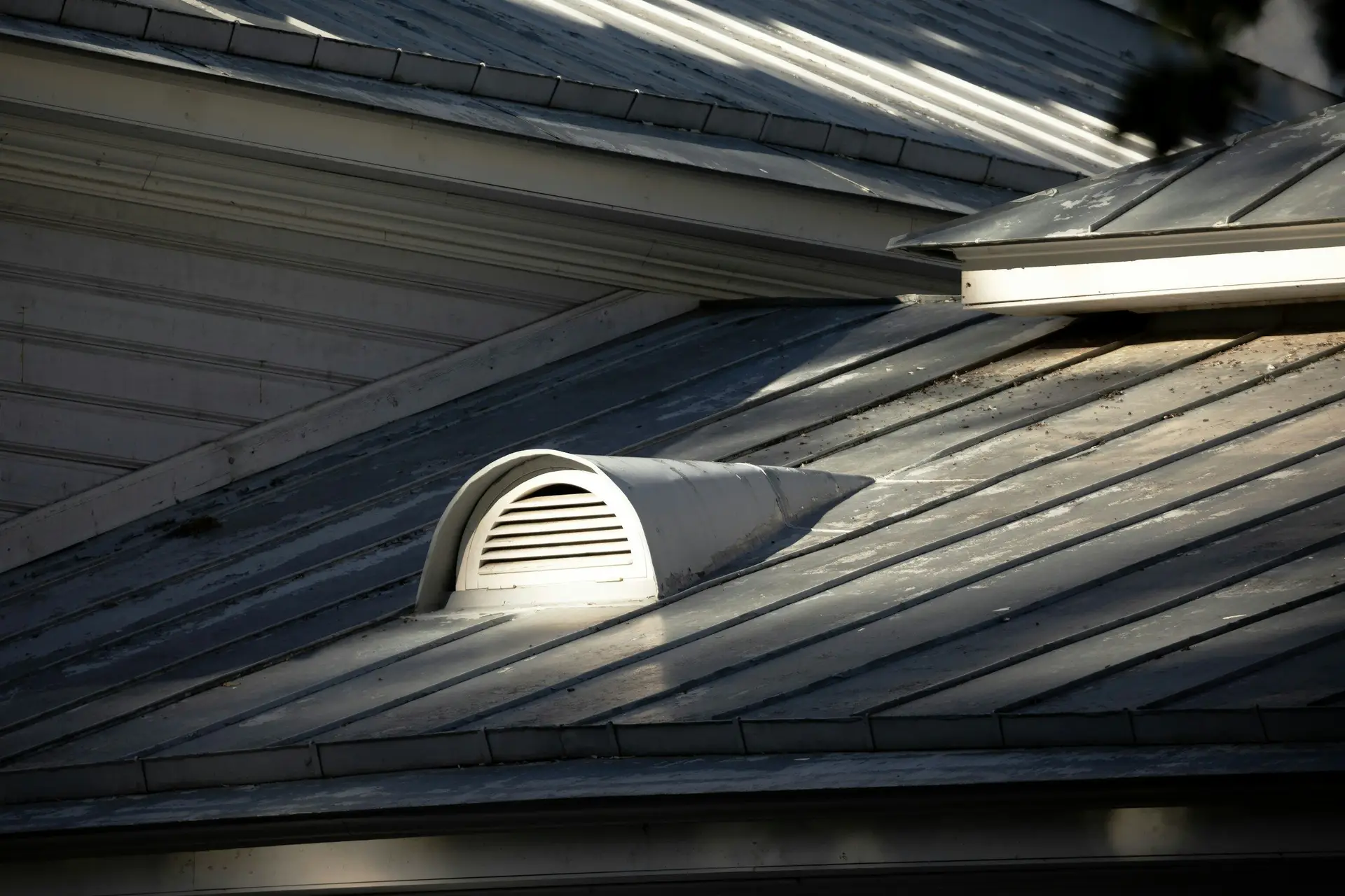 Metal roof with a roof vent up close