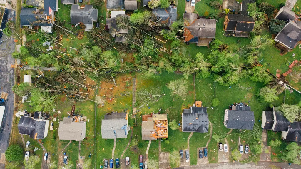 Aerial view of homes with roofs torn open after a storm