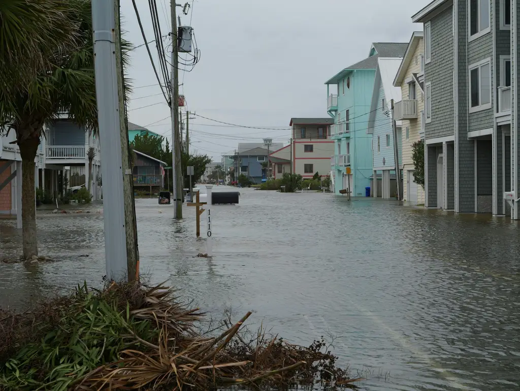 Flooded street lined with homes after a storm